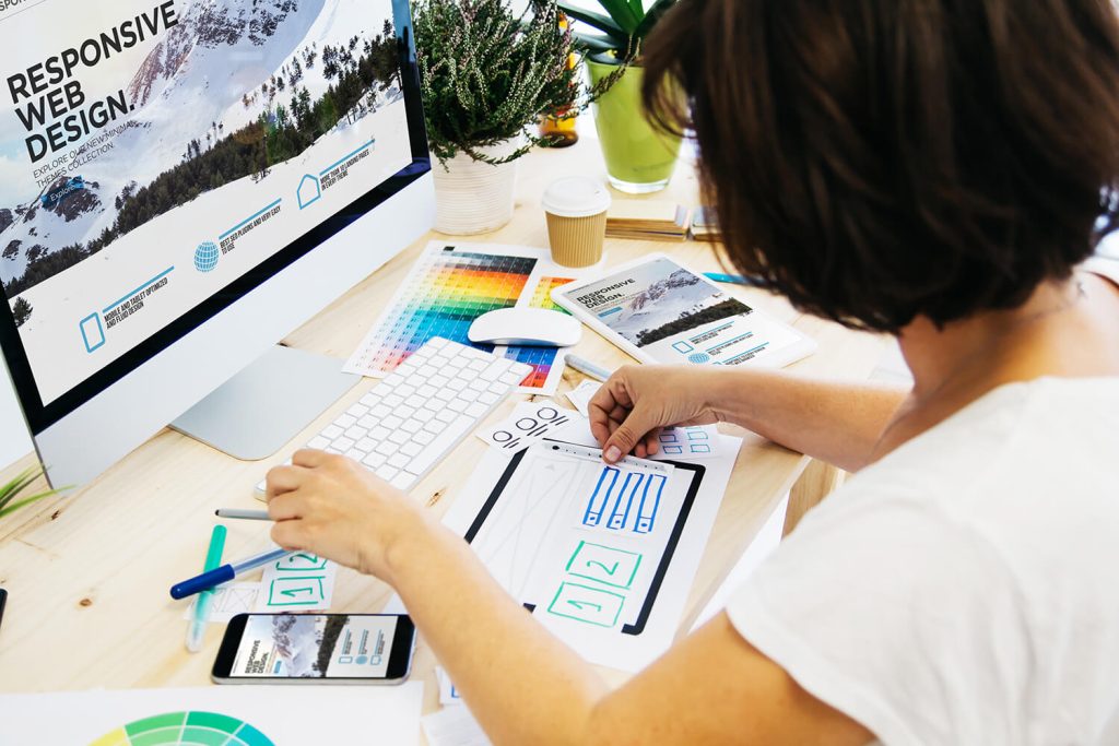 Woman at computer designing website